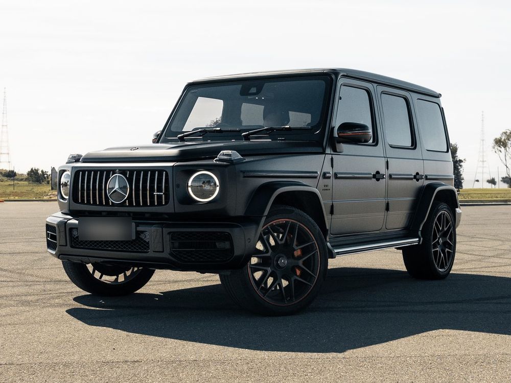 Matte black Mercedes-AMG G63 Stage 2, front three-quarter view on an open car park
