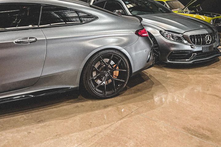 Two Mercedes-AMG C63 S coupes in the CADE Technologies workshop