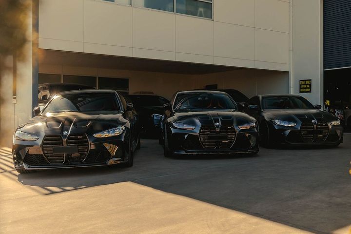 Three BMW G-series M cars lined up outside the CADE Technologies workshop