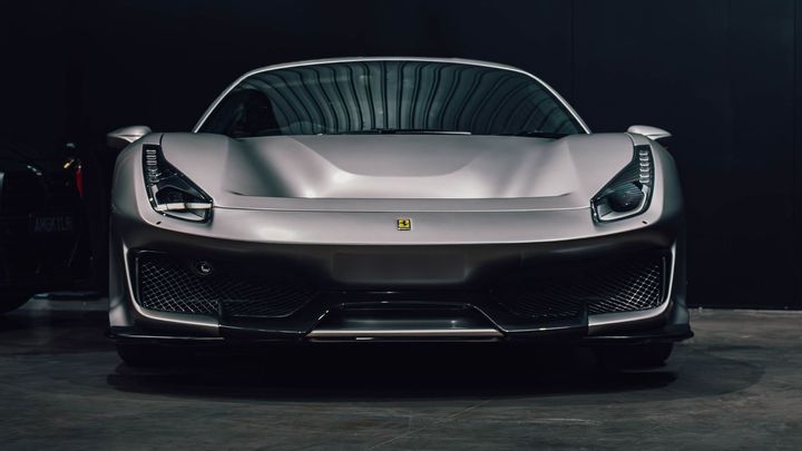Silver Ferrari 488 Pista, front view, in the CADE Technologies workshop