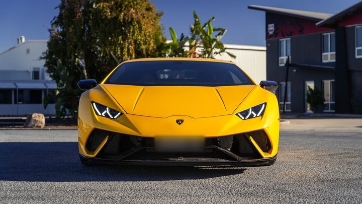 Yellow Lamborghini Huracán Performante parked outside the workshop, front view