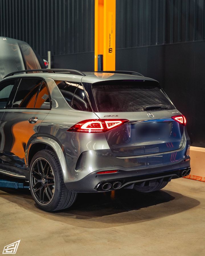 Grey Mercedes-AMG GLE in the CADE Technologies workshop, rear three-quarter view
