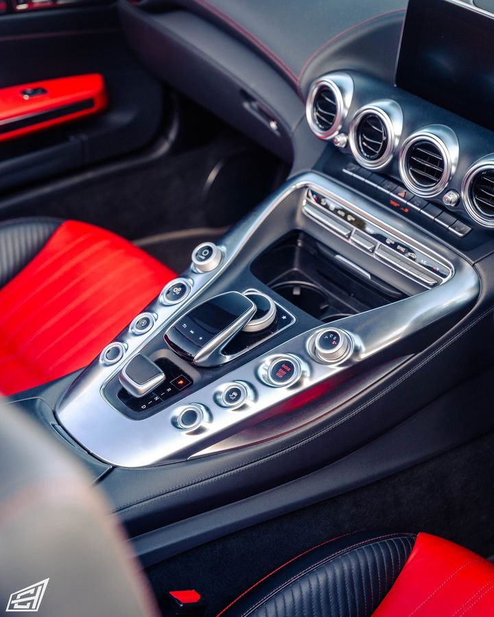Centre console of a Mercedes-AMG GT with red leather seats and brushed-aluminium switchgear