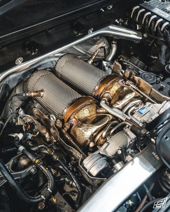 Porsche Cayenne twin-turbo V8 engine bay with heat-wrapped downpipes fitted
