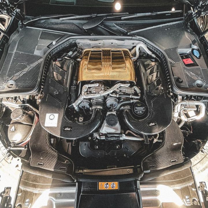 CADE carbon fibre air intake kit fitted either side of the engine in a Mercedes-AMG V8 engine bay