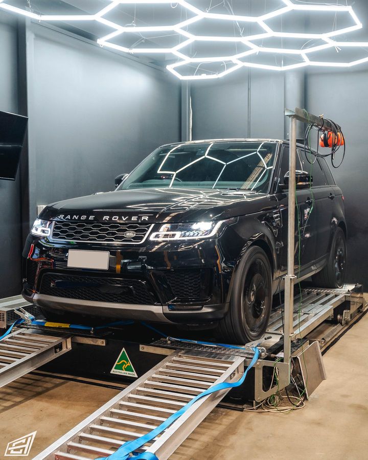 Black Range Rover Sport on the dyno beneath hexagonal LED lights