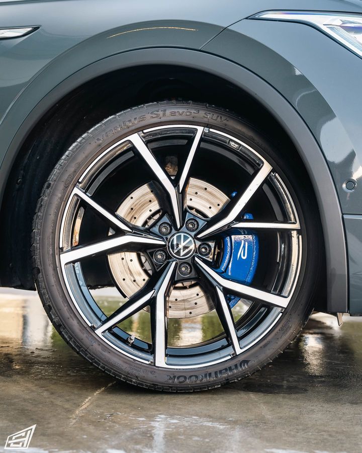 Close-up of a Volkswagen alloy wheel with a blue R brake caliper