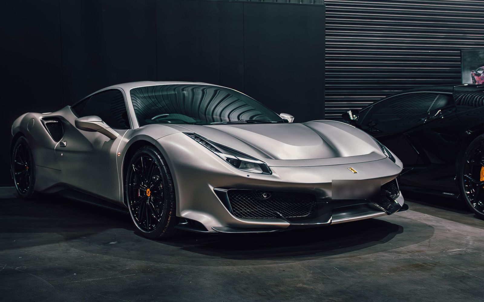 Silver Ferrari 488 Pista in the CADE Technologies workshop