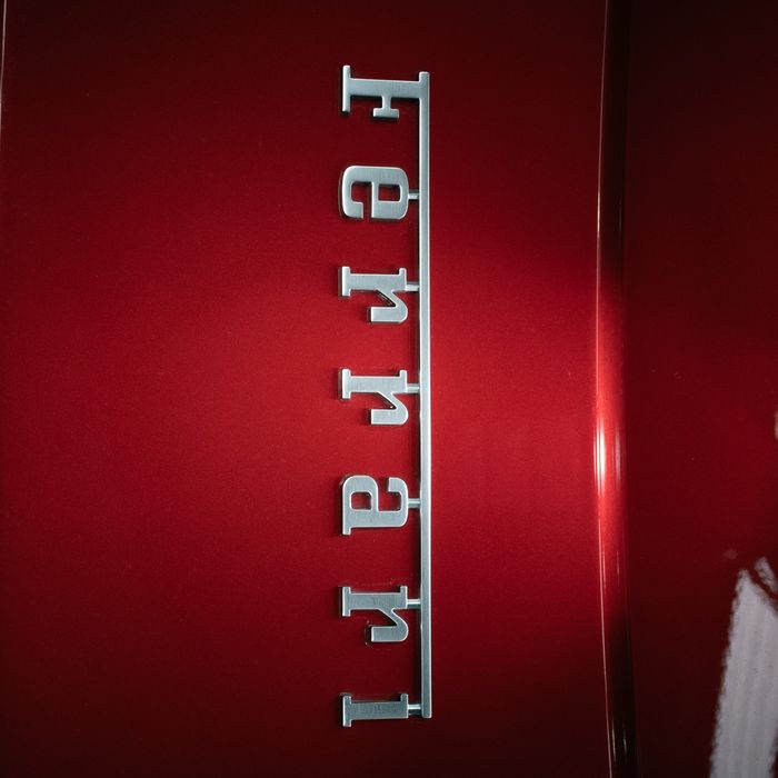 Chrome Ferrari script on the flank of a red Ferrari 296 GTB