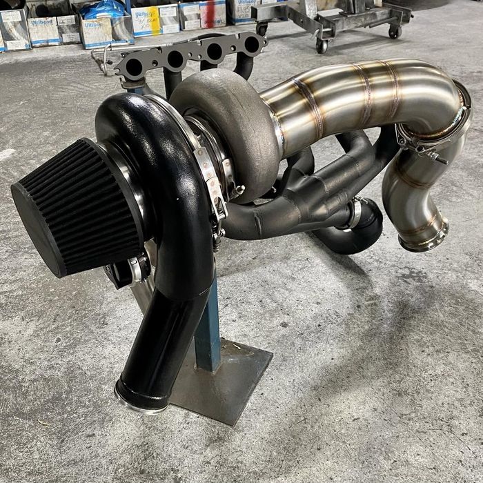 Custom stainless turbo manifold with an open filter, fabricated in the CADE workshop