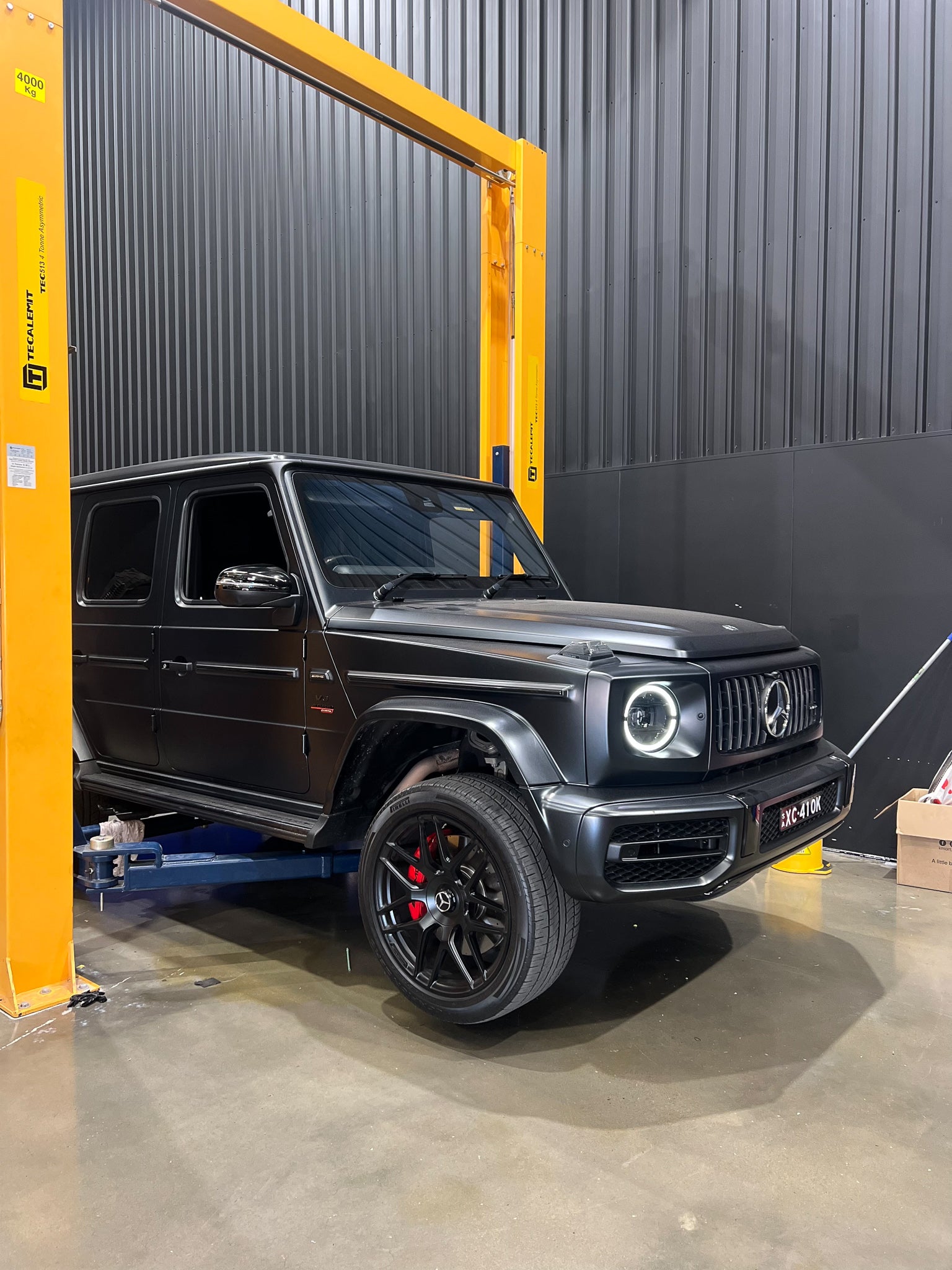 Matte Mercedes-AMG G63 raised on a hoist in the CADE Technologies workshop