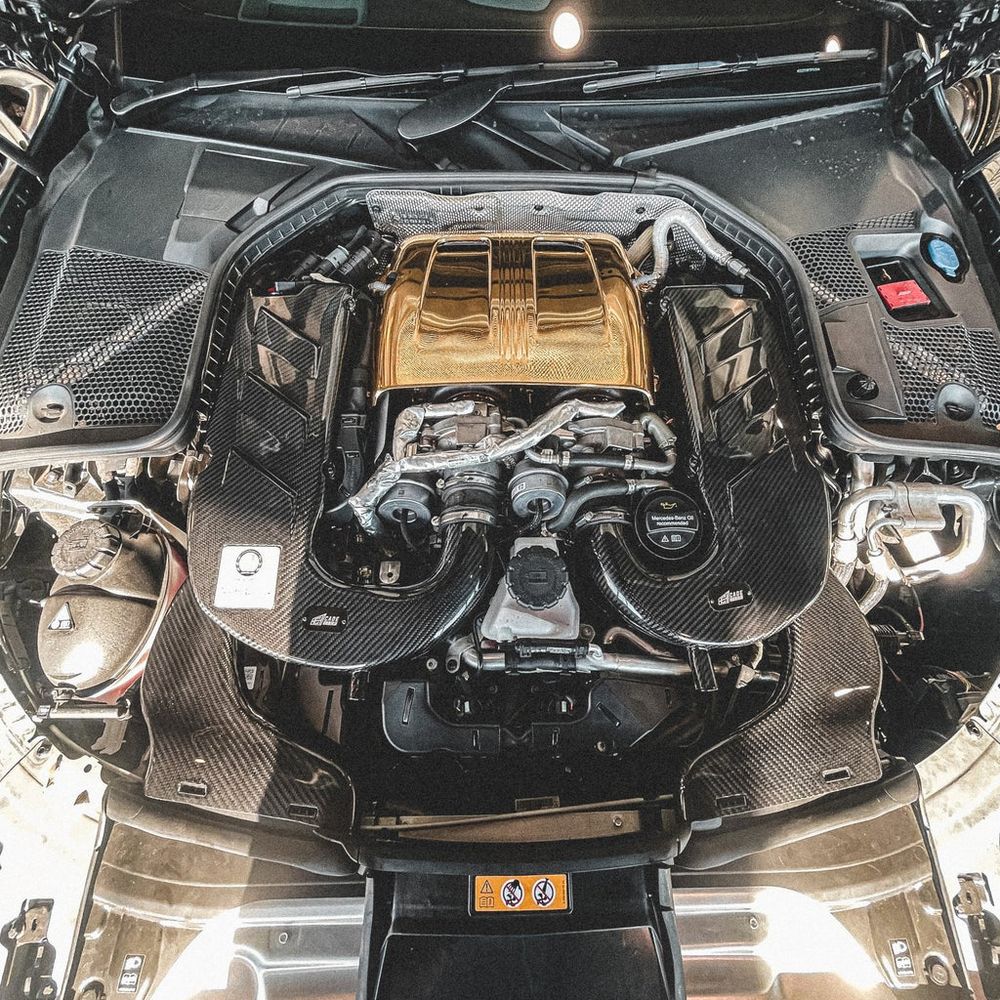 CADE carbon fibre air intake kit fitted either side of the engine in a Mercedes-AMG V8 engine bay