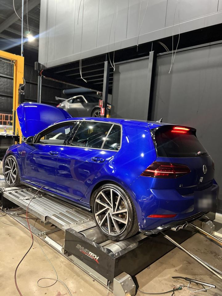 Blue Volkswagen Golf R (Mk7.5) on the Dynotech dyno with its bonnet up, rear three-quarter view